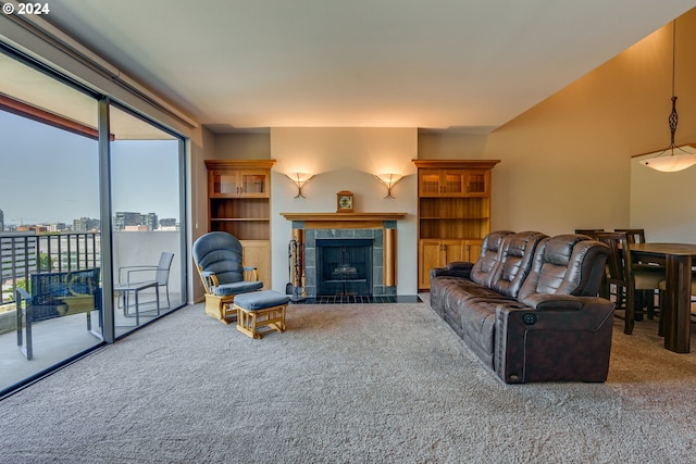 carpeted living room featuring a tiled fireplace