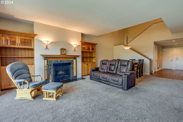 carpeted living room with a tiled fireplace