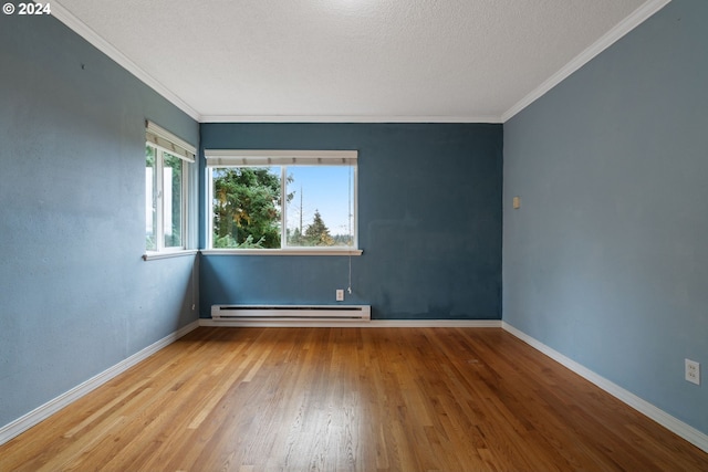 unfurnished room featuring wood-type flooring, a textured ceiling, baseboard heating, and ornamental molding