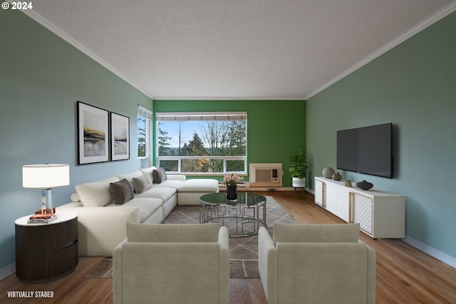 living room with hardwood / wood-style floors, a textured ceiling, and ornamental molding