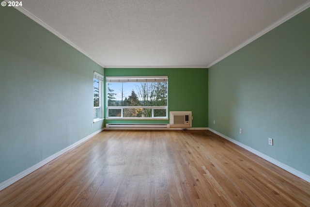 unfurnished room with ornamental molding, a textured ceiling, a baseboard radiator, and light hardwood / wood-style flooring