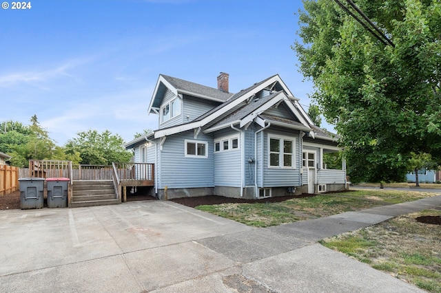 view of side of property with a deck