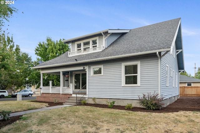 view of front of home with a front yard and a porch