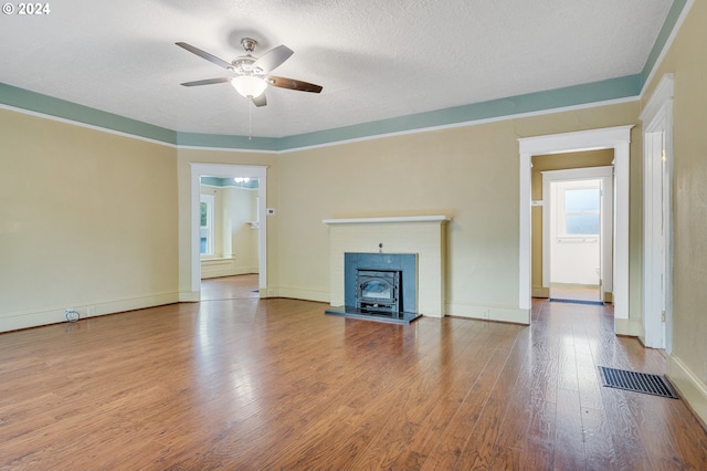 unfurnished living room featuring a textured ceiling, hardwood / wood-style floors, and ceiling fan