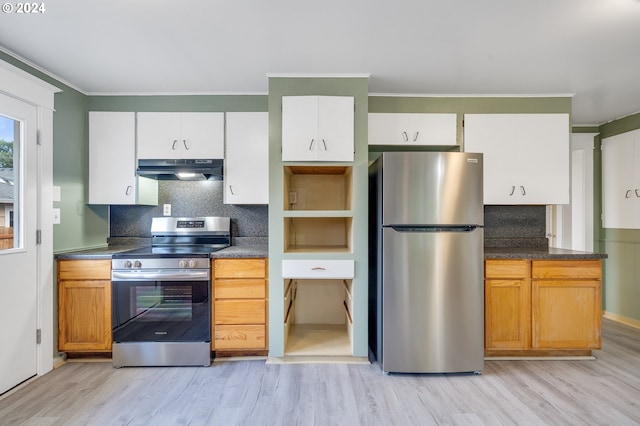 kitchen featuring appliances with stainless steel finishes, crown molding, white cabinetry, and light hardwood / wood-style flooring