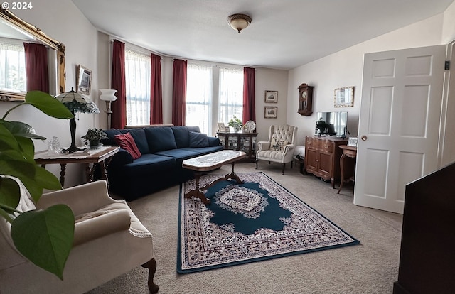 carpeted living room featuring lofted ceiling