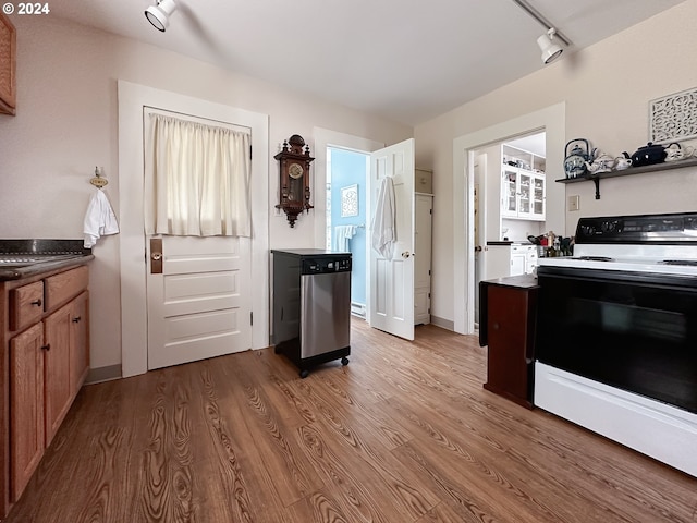 kitchen featuring track lighting, electric range, and hardwood / wood-style flooring