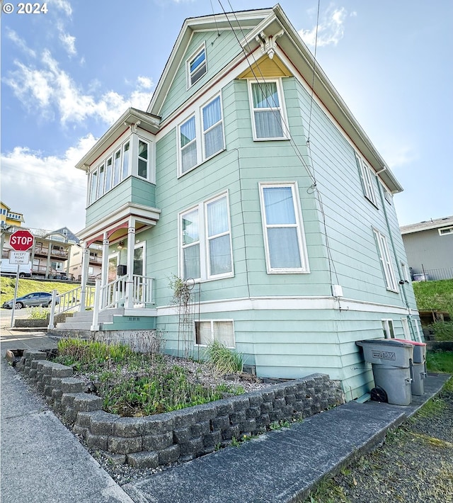 view of side of property with covered porch