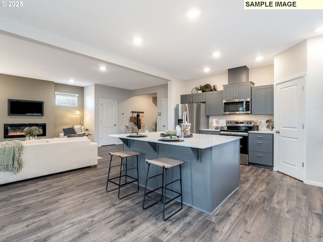 kitchen featuring stainless steel appliances, dark brown cabinets, a center island, and sink