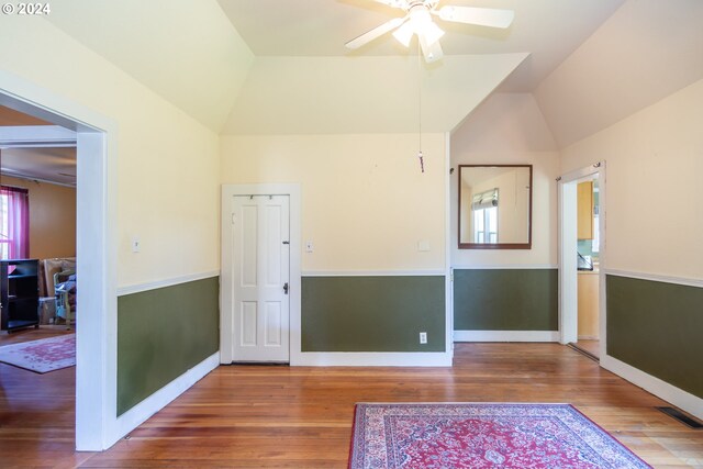 foyer entrance featuring vaulted ceiling, hardwood / wood-style floors, and ceiling fan