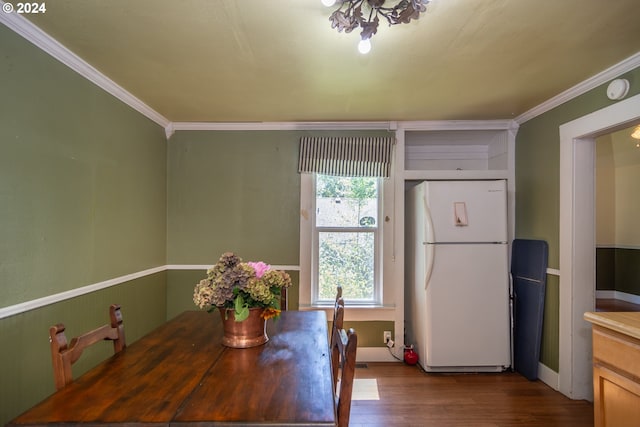 dining room featuring dark wood-style floors and ornamental molding