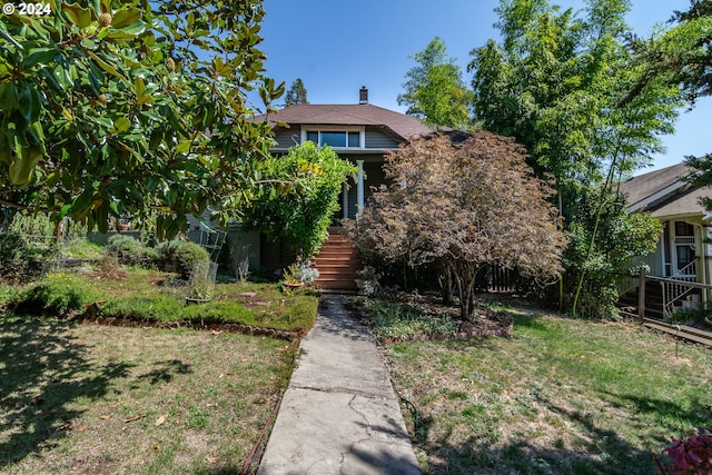 obstructed view of property featuring a front yard