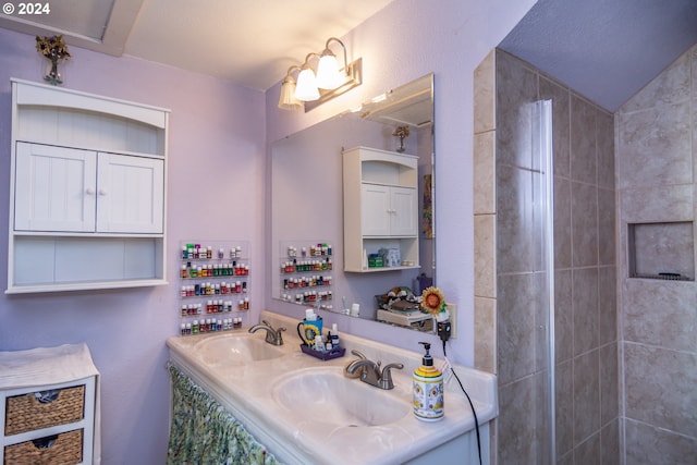 bathroom featuring vanity and lofted ceiling