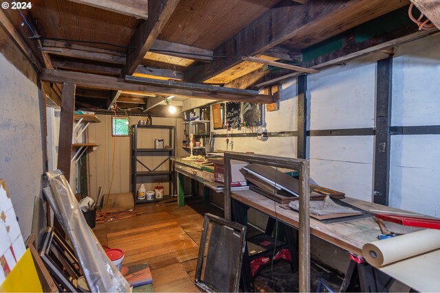 basement with wood-type flooring and a workshop area