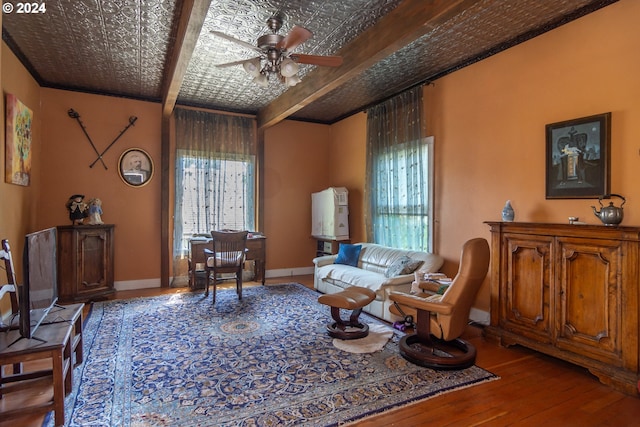 living room with a healthy amount of sunlight, ceiling fan, hardwood / wood-style floors, and beam ceiling