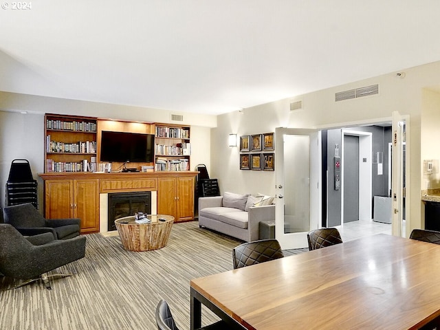 carpeted living room with elevator