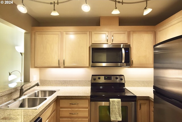 kitchen featuring light brown cabinetry, sink, appliances with stainless steel finishes, and track lighting