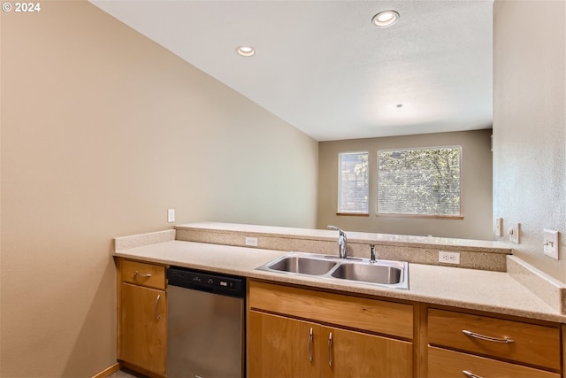 kitchen with kitchen peninsula, dishwasher, lofted ceiling, and sink