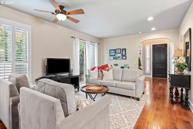 living room with hardwood / wood-style flooring and ceiling fan