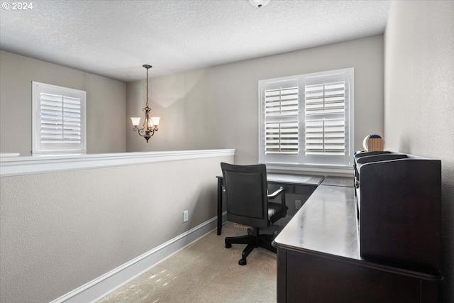 office area featuring a textured ceiling, light colored carpet, and a notable chandelier