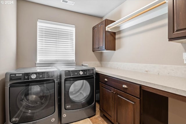 laundry area with cabinets and independent washer and dryer