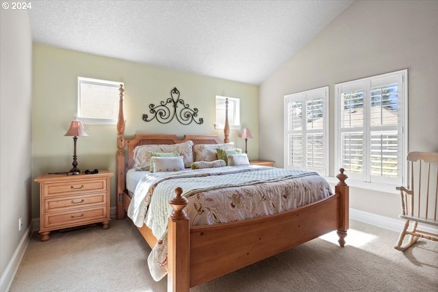 carpeted bedroom with a textured ceiling and vaulted ceiling