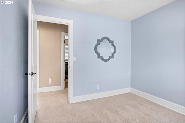 unfurnished room with light colored carpet