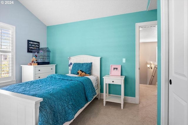 bedroom with carpet floors and vaulted ceiling