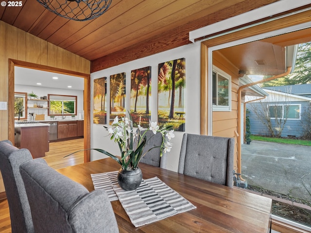 sunroom / solarium featuring plenty of natural light and wooden ceiling