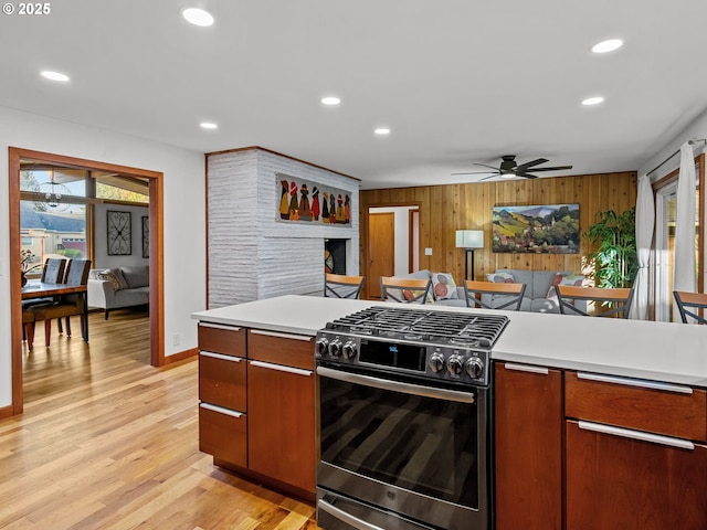 kitchen with recessed lighting, gas range, light wood-style floors, and light countertops