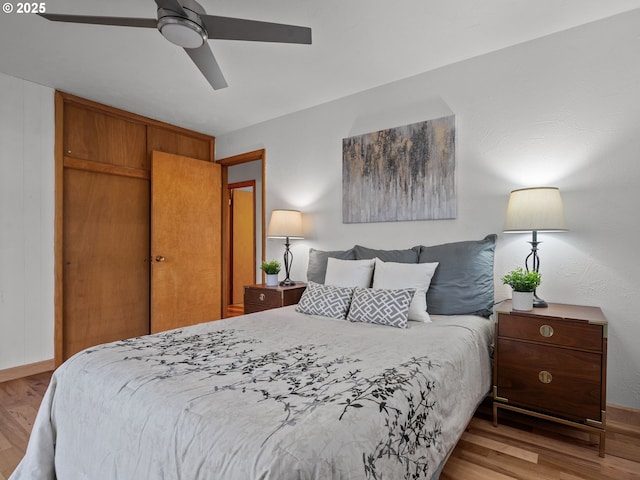 bedroom with a ceiling fan and light wood-type flooring