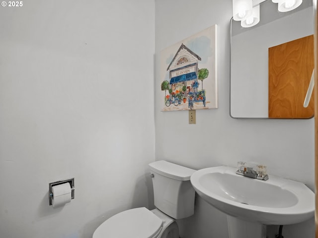 bathroom featuring toilet and a sink