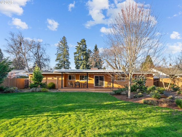 back of house featuring a deck, a yard, and fence