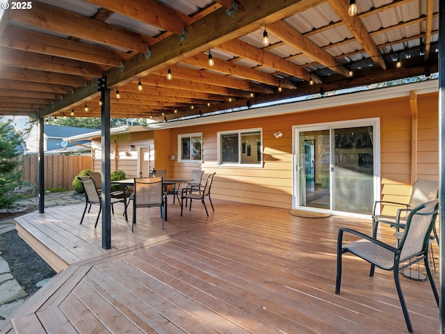 wooden deck featuring outdoor dining area and fence