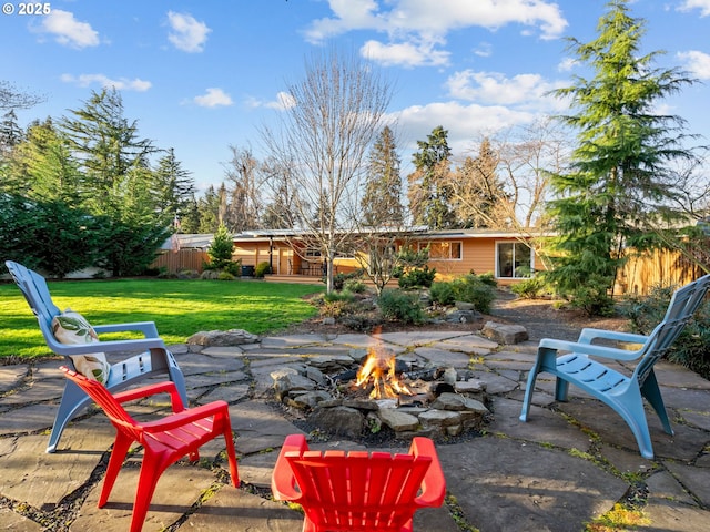 view of patio featuring a fire pit and fence