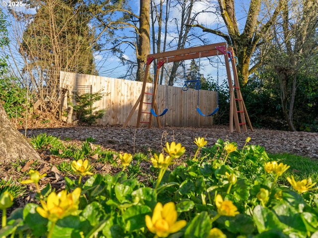 view of yard with a playground and fence