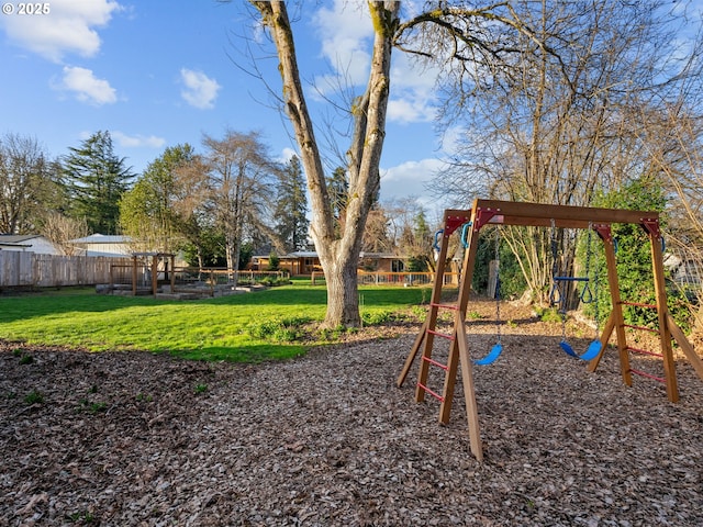 view of jungle gym featuring a yard and fence