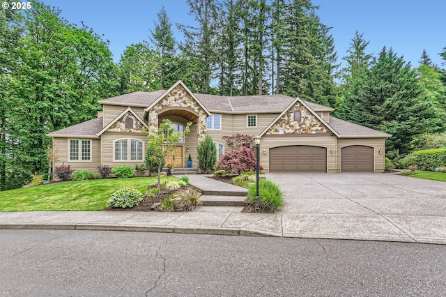 13516 NW Glendoveer Dr, Portland, OR 97231 - view of front of house featuring a garage, driveway, a front lawn, stone siding, and roof with shingles