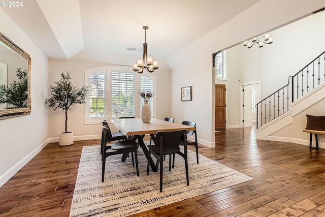 13516 NW Glendoveer Dr, Portland, OR 97231 - dining room featuring a chandelier, dark wood-type flooring, stairway, and lofted ceiling