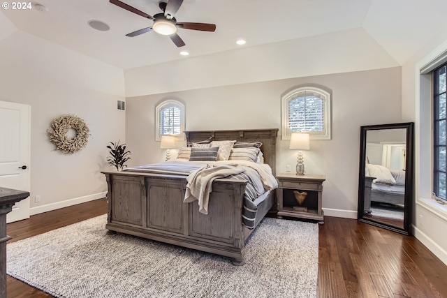 bedroom featuring ceiling fan, dark hardwood / wood-style flooring, and lofted ceiling