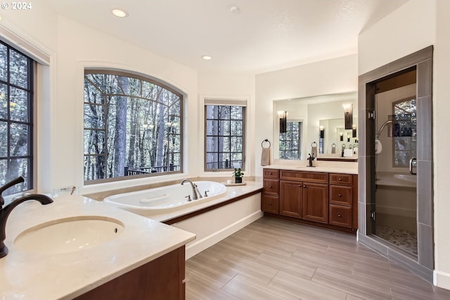 13516 NW Glendoveer Dr, Portland, OR 97231 - full bathroom with two vanities, a bath, a shower stall, and recessed lighting