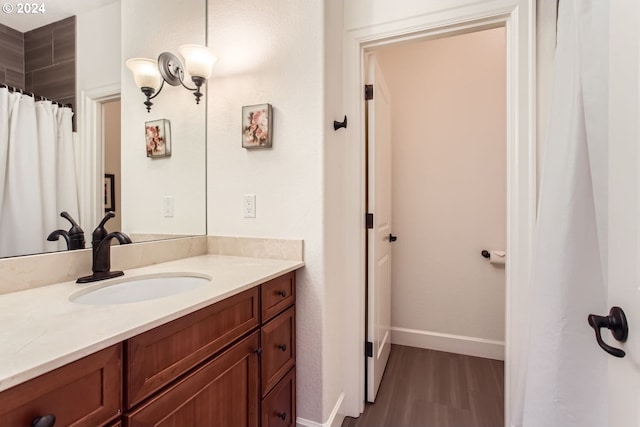 bathroom with vanity and wood-type flooring