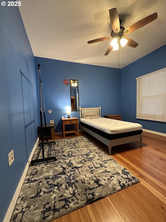 bedroom with wood-type flooring and ceiling fan