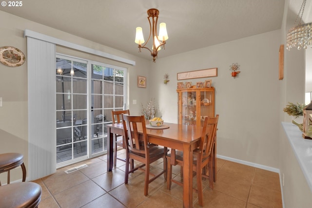 87973 Sherwood St, Veneta, OR 97487 - dining space featuring a chandelier, light tile patterned floors, and baseboards