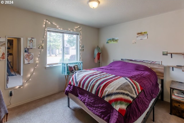 bedroom with carpet and a textured ceiling