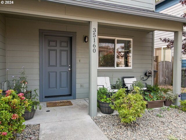 doorway to property featuring covered porch