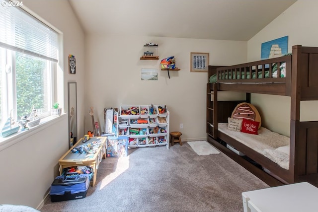 carpeted bedroom featuring multiple windows and lofted ceiling