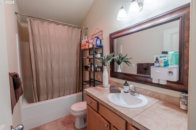 full bathroom with vanity, vaulted ceiling, tile patterned flooring, toilet, and shower / bathtub combination with curtain