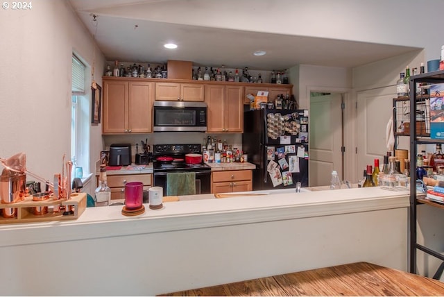 kitchen featuring black appliances and hardwood / wood-style floors