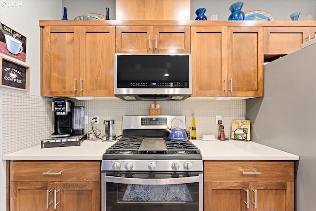 kitchen featuring appliances with stainless steel finishes and tasteful backsplash